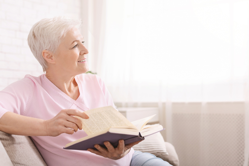 Dreamy senior woman relaxing at home with favorite book How Retiring At Glen Mills, PA Assisted Living Makes You Stay Positive