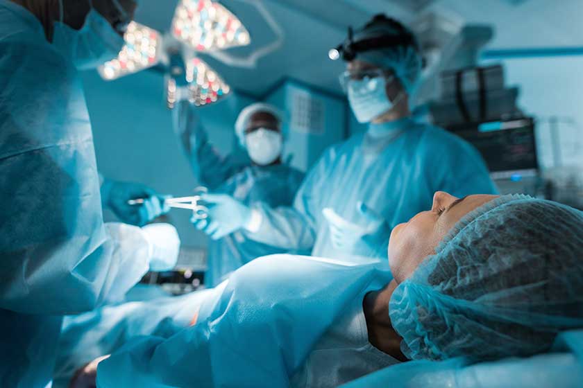 Patient lying on operating table during surgery Patient lying on operating table during surgery