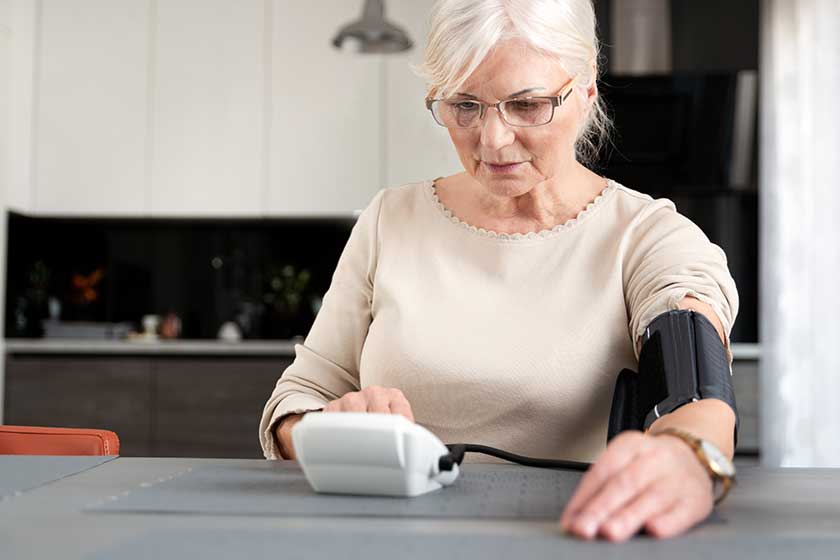 Senior adult woman measuring blood pressure
