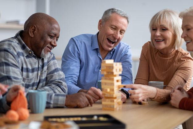 Cheerful-senior-people-paying-table-games-togethe Cheerful-senior-people-paying-table-games-togethe