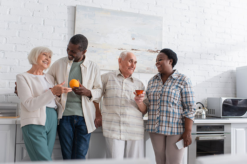 Positive-interracial-senior-people-tea-fruit-smartphone-talking-nursing-home Positive-interracial-senior-people-tea-fruit-smartphone-talking-nursing-home