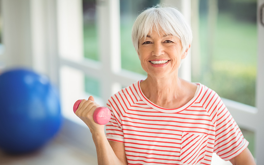 Portrait-senior-woman-exercising-dumbbell-home
