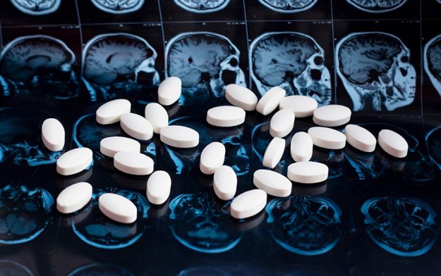 White-pharmaceutical-medicine-pills-magnetic-brain-resonance-scan-mri-background