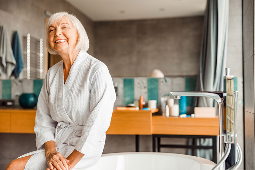 Cheerful elderly woman relaxing in spa salon Cheerful elderly woman relaxing in spa salon