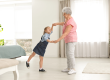 Cute girl and her grandmother dancing