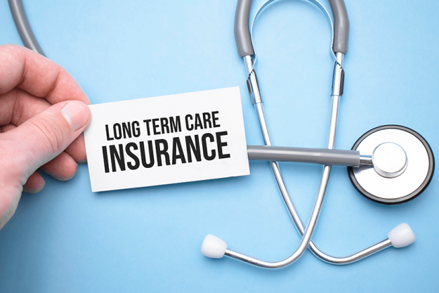 The doctor's hands holds a business card with the text