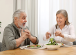Happy senior couple having dinner at home