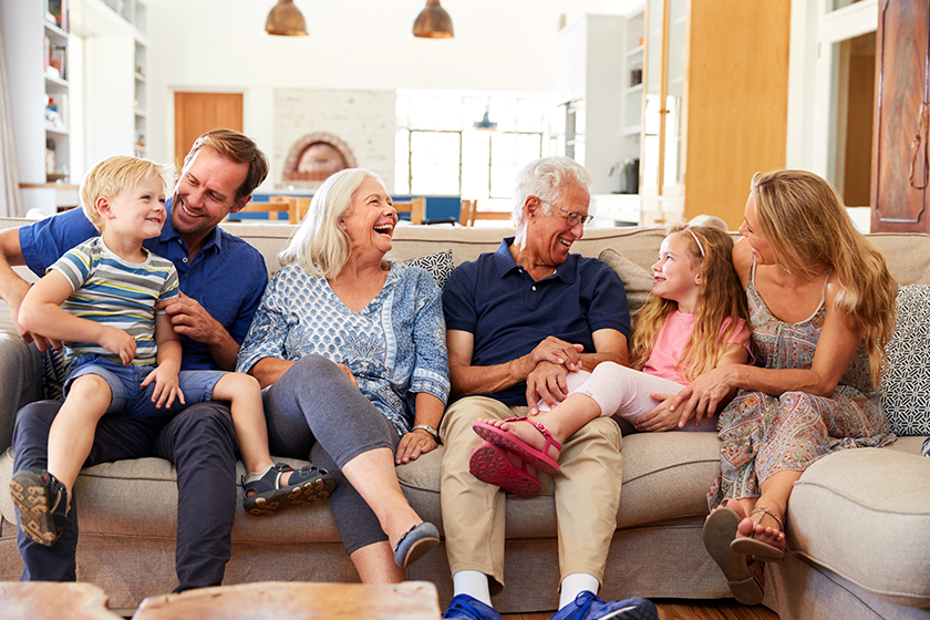Multi-Generation Family Sitting On Sofa