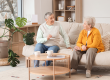 Senior female friends chatting on sofa